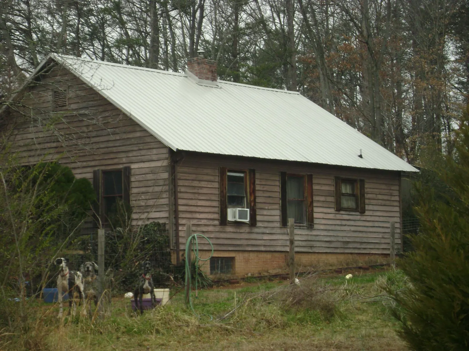 White metal roof on an old wood sided farmhouse, from a Metal Roof Installation job in New Auburn